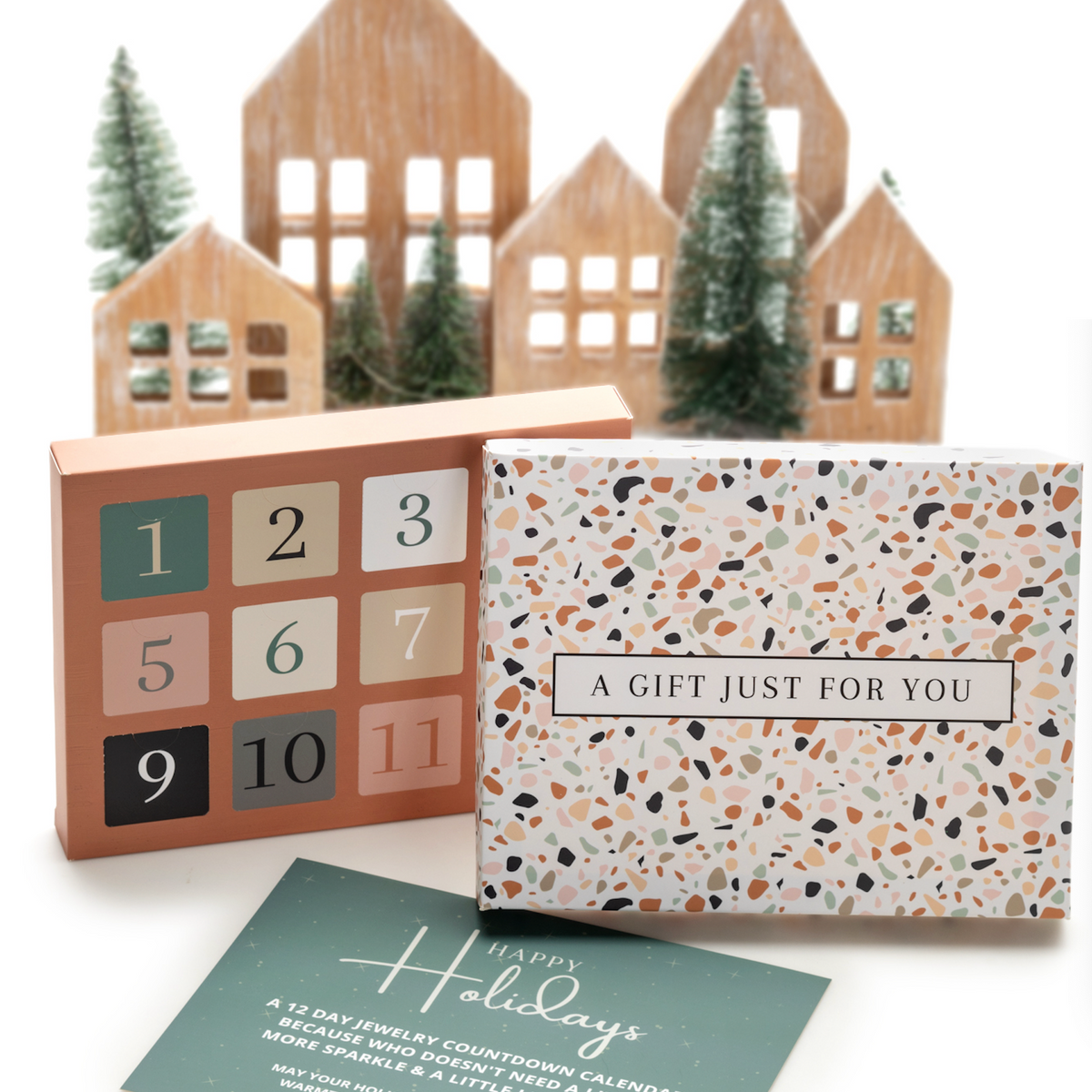 12 Days of Christmas gift display with a numbered calendar, terrazzo-patterned gift box and festive decorations
