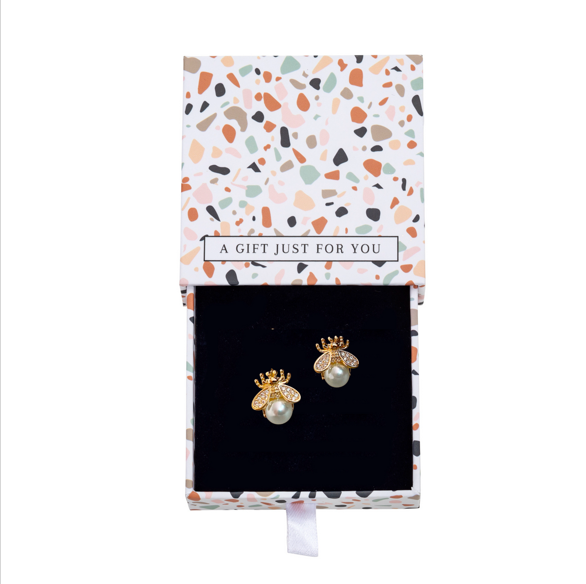 Gold-tone bee earrings with white faux pearls inside a patterned gift box