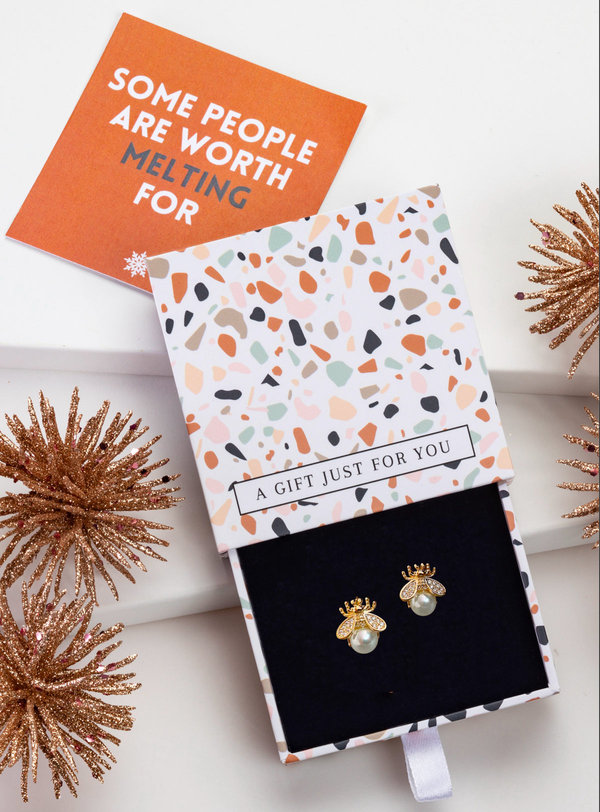 Faux pearl bee stud earrings in an open patterned gift box with festive styling