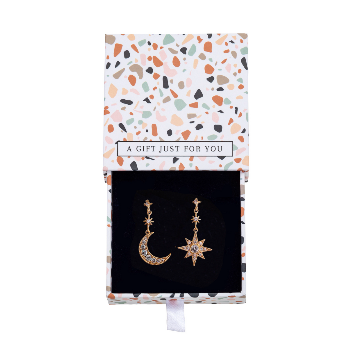 Gold-tone moon and star earrings inside an open patterned gift box