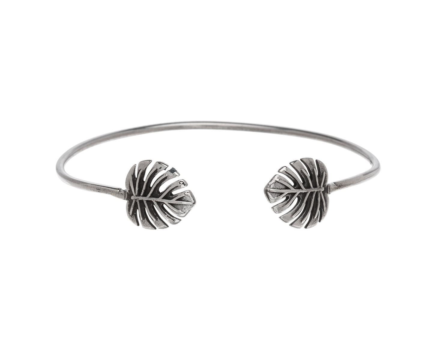 Sterling silver open cuff bracelet with two sculpted tropical leaf ends and subtle oxidised detail, minimalist adjustable women’s jewellery.