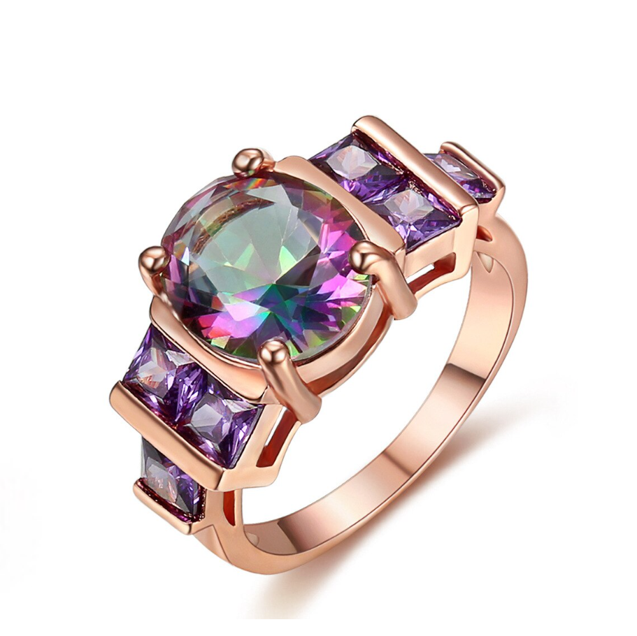 A rose goldtone ring with a central Mystic Topaz cubic zirconia stone, surrounded by smaller cubic zirconia pieces, with a polished and elegant finish.