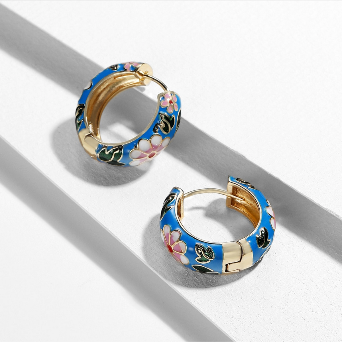 Blue floral enamel huggie hoop earrings with gold-tone edges