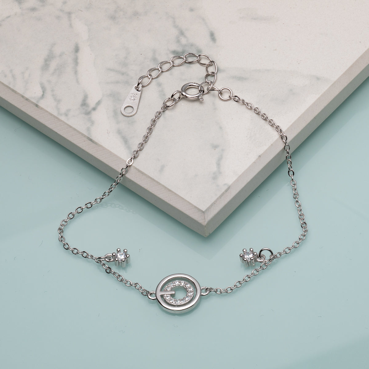 Rhodium-plated sterling silver open circle bracelet with pavé cubic zirconia and adjustable chain, minimalist women’s jewellery.