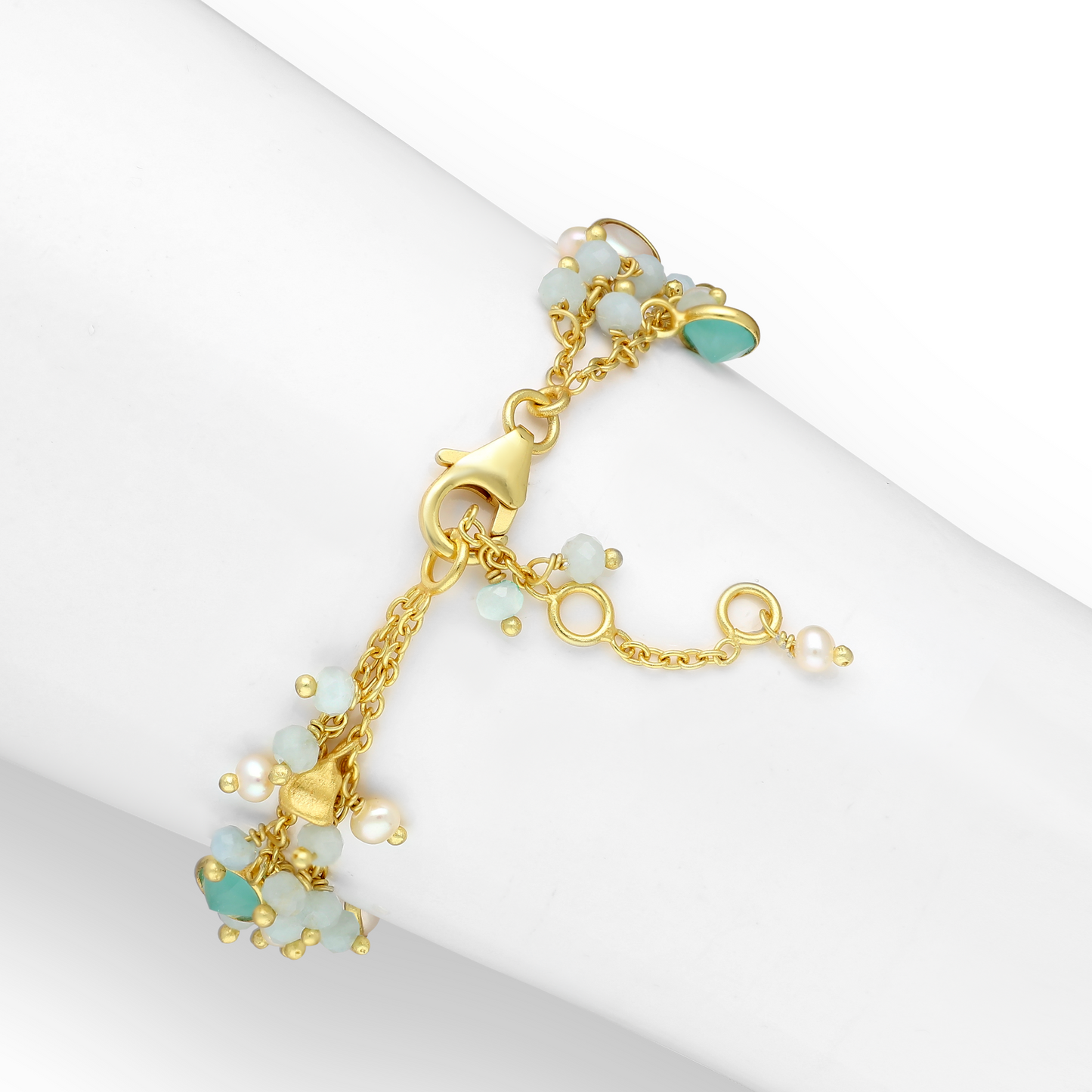 Gold-plated sterling silver station bracelet with freshwater pearls and mixed gemstones in a delicate branch design.
