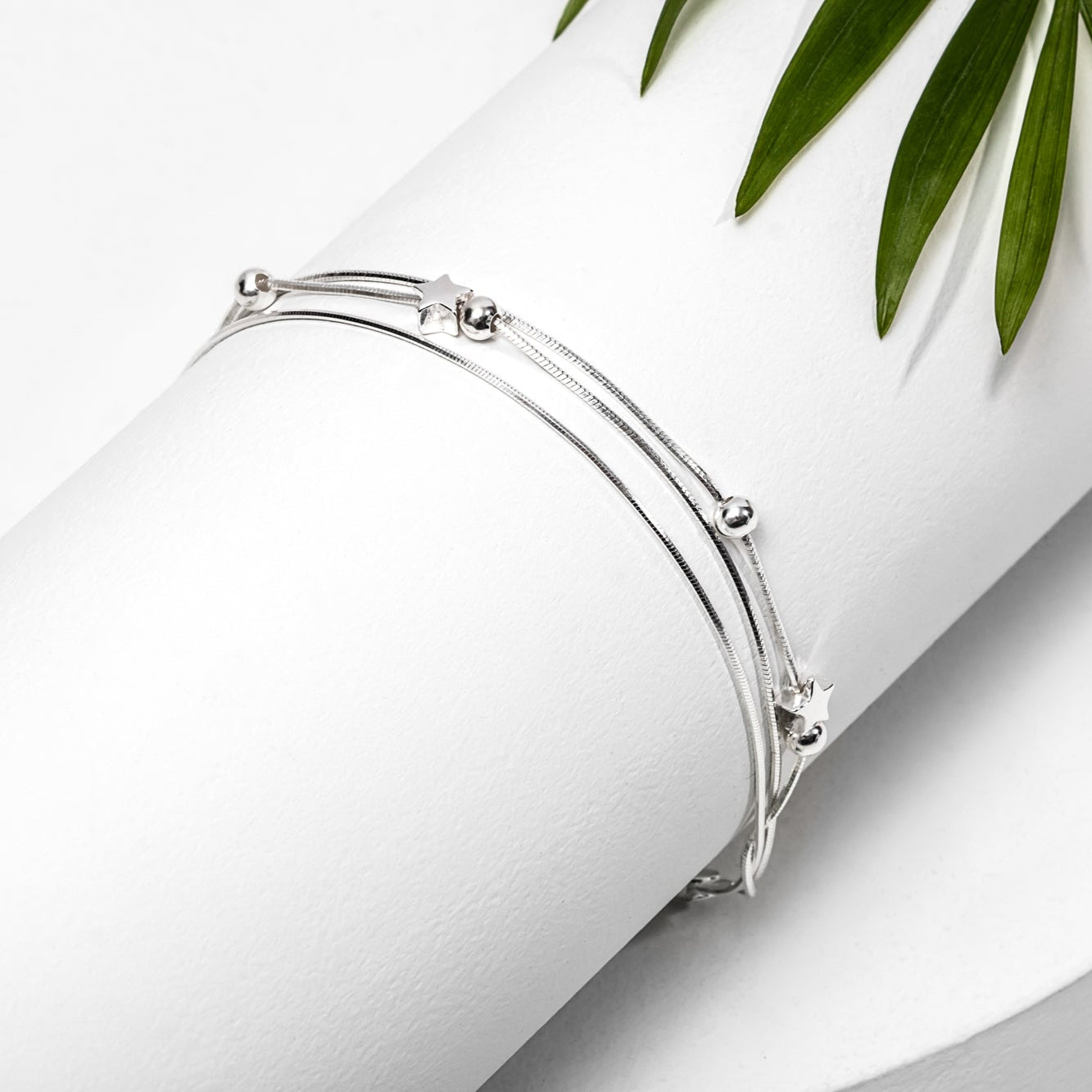 A sterling silver multi-strand ball bracelet with a secure lobster clasp, displayed on a white background.