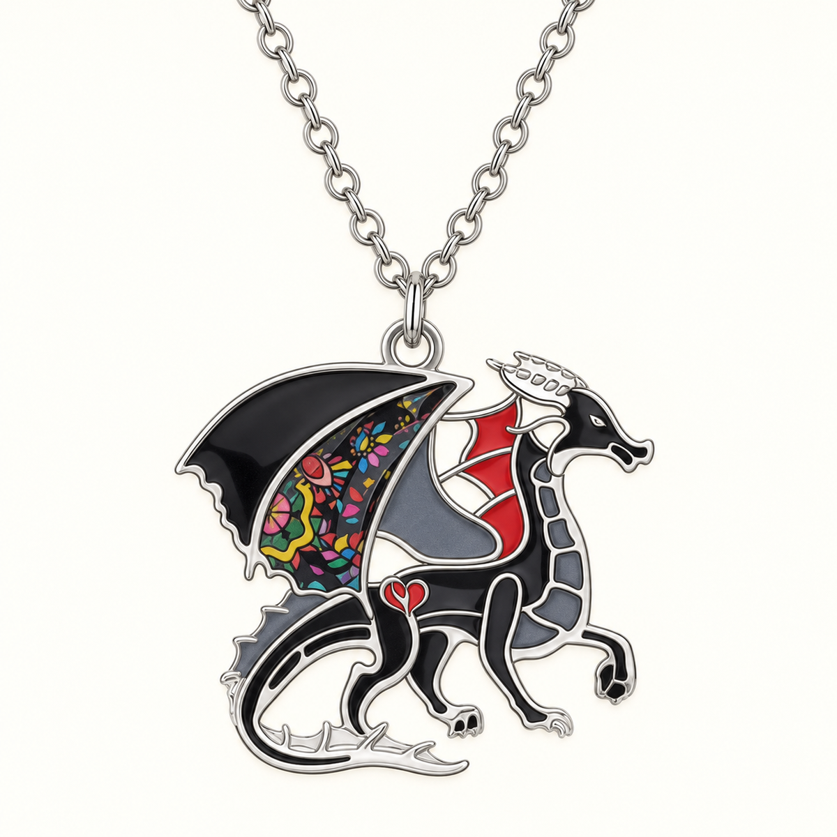 Close-up of black enamel dragon pendant with red accents and a floral wing panel