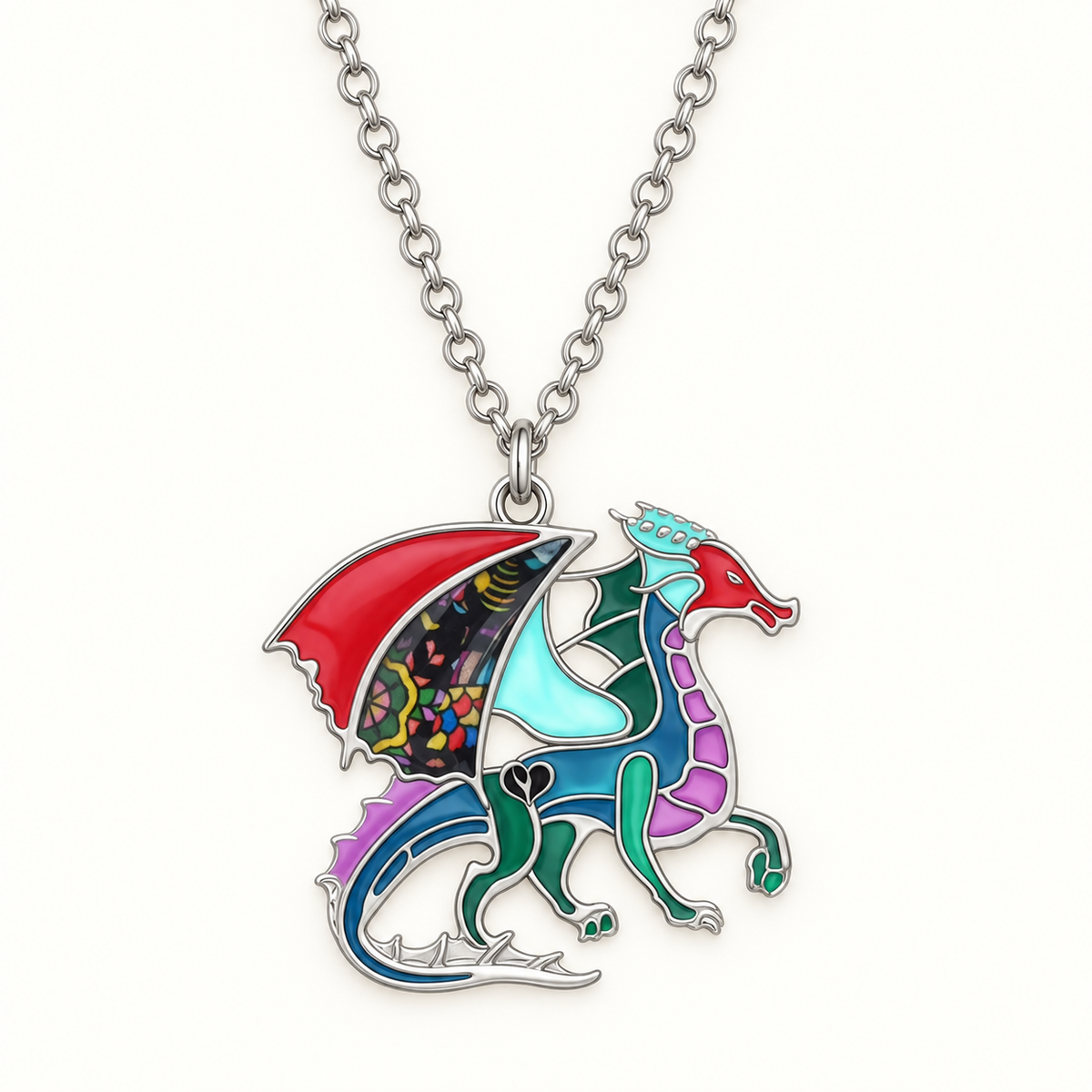 Close-up of multicolour enamel dragon pendant with floral wing panel and silver-tone outlines