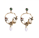 Brass circular earrings with flying bird details and dangling imitation pearls