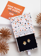 Faux pearl bee stud earrings in an open patterned gift box with festive styling