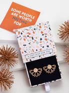 Gold-tone crystal lotus ear jackets in a patterned gift box