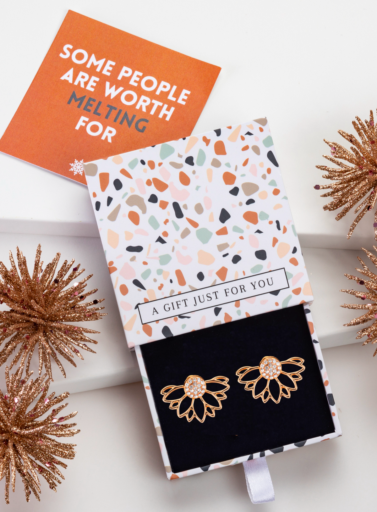 Gold-tone crystal lotus ear jackets in a patterned gift box