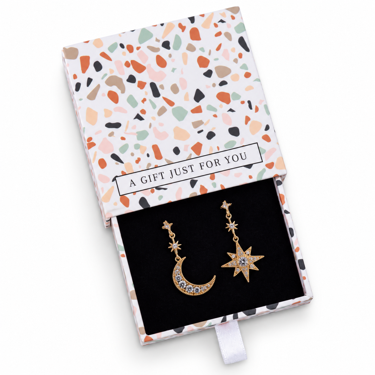 Gold-tone cubic zirconia moon and star drop earrings in a gift box on a white background