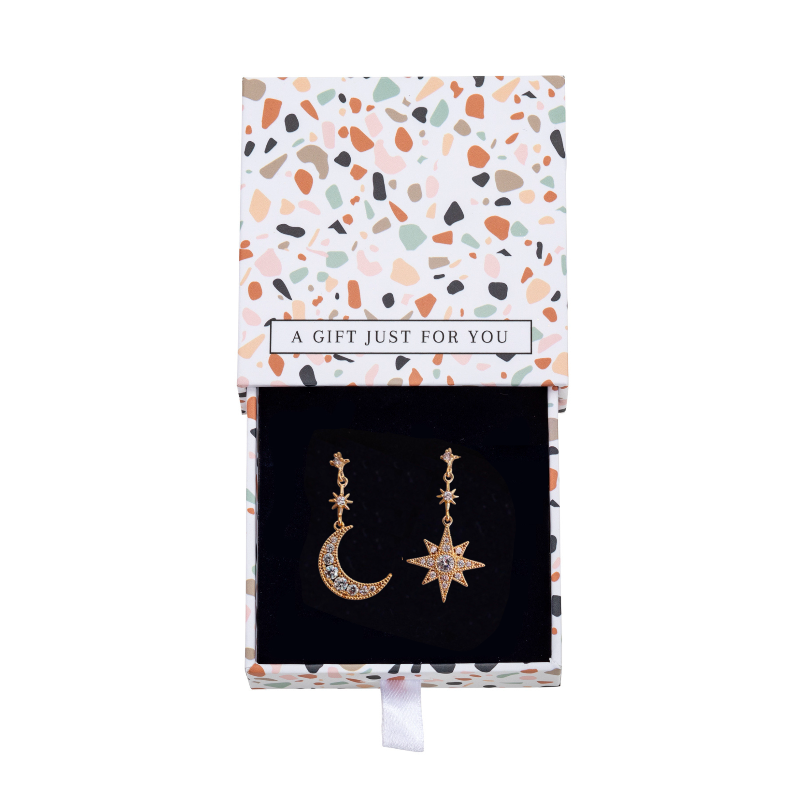 Gold-tone moon and star earrings inside an open patterned gift box