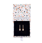 Bar and baguette crystal earrings inside an open patterned gift box