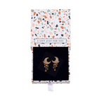 Goldtone moon and star earrings in an open floral gift box