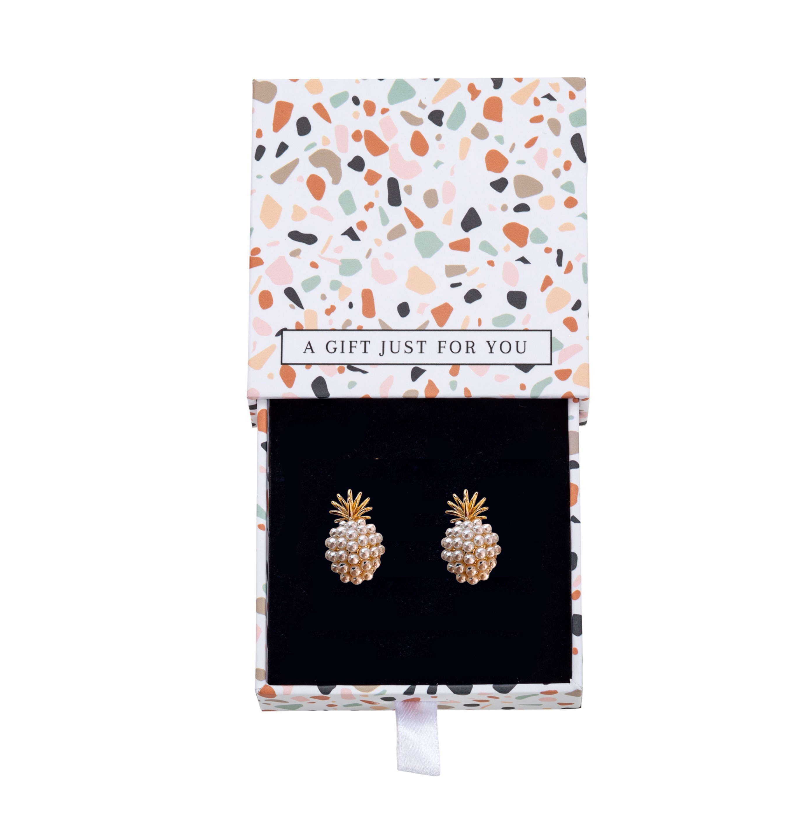 Gold-tone pineapple earrings with white faux pearls inside a patterned gift box