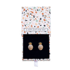 Gold-tone pineapple earrings with white faux pearls inside a patterned gift box