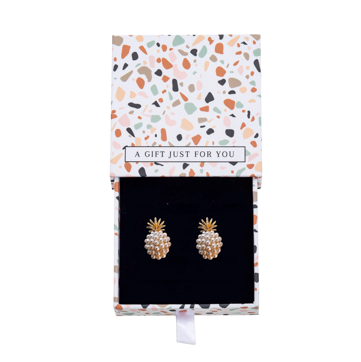 Gold-tone pineapple earrings with white faux pearls inside a patterned gift box