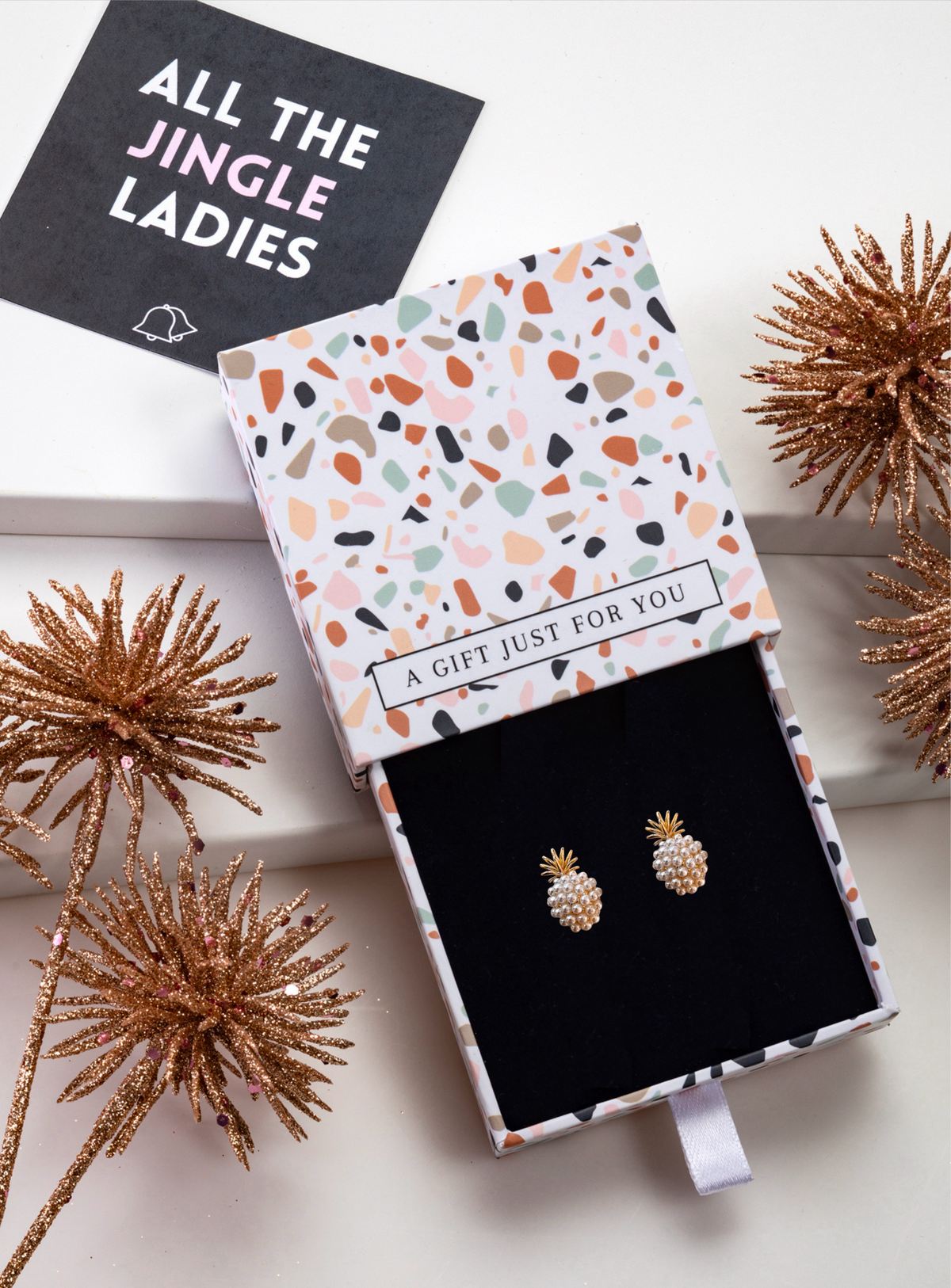 Faux pearl pineapple stud earrings in an open gift box with festive styling