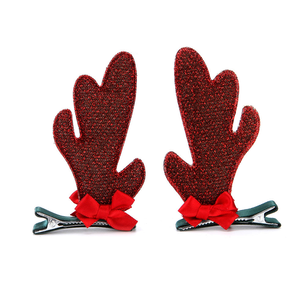 Pair of brown antler hair clips with red bows and green clip bases