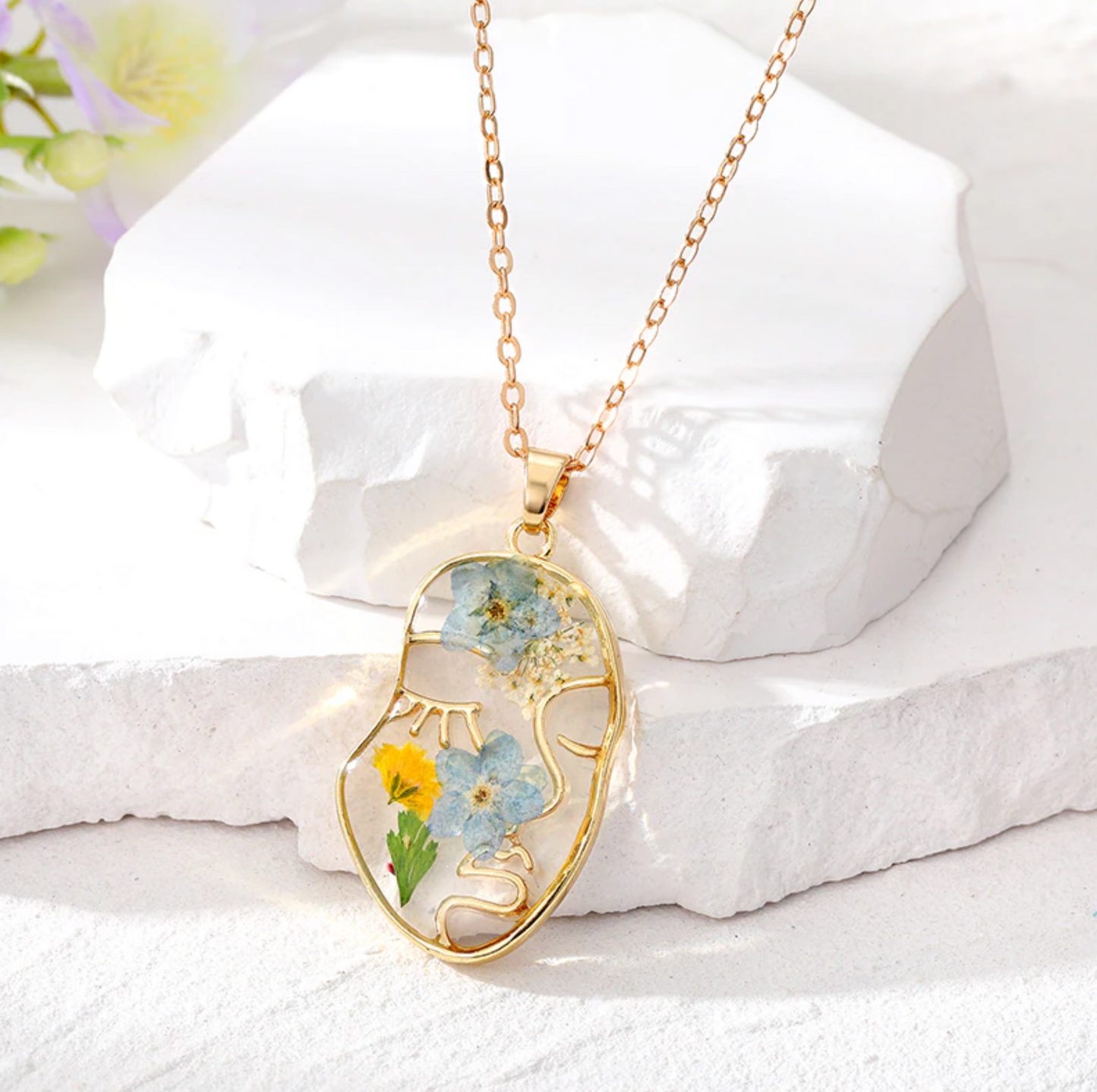 Goldtone Transparent Floral Abstract Face Pendant Necklace