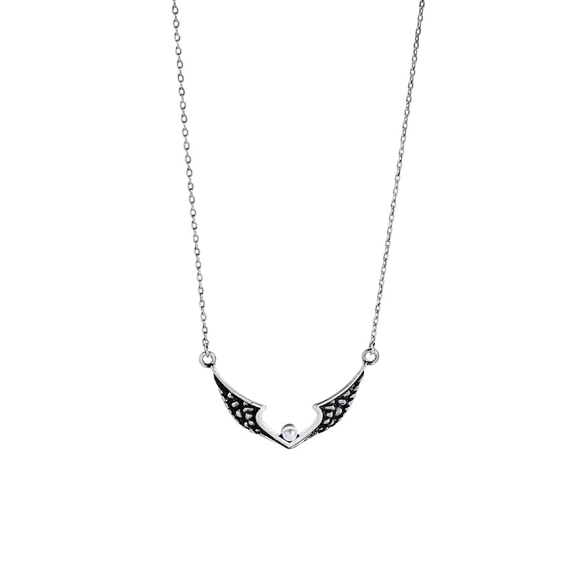 Silver-tone chain necklace with a black wing pendant and clear centre stone