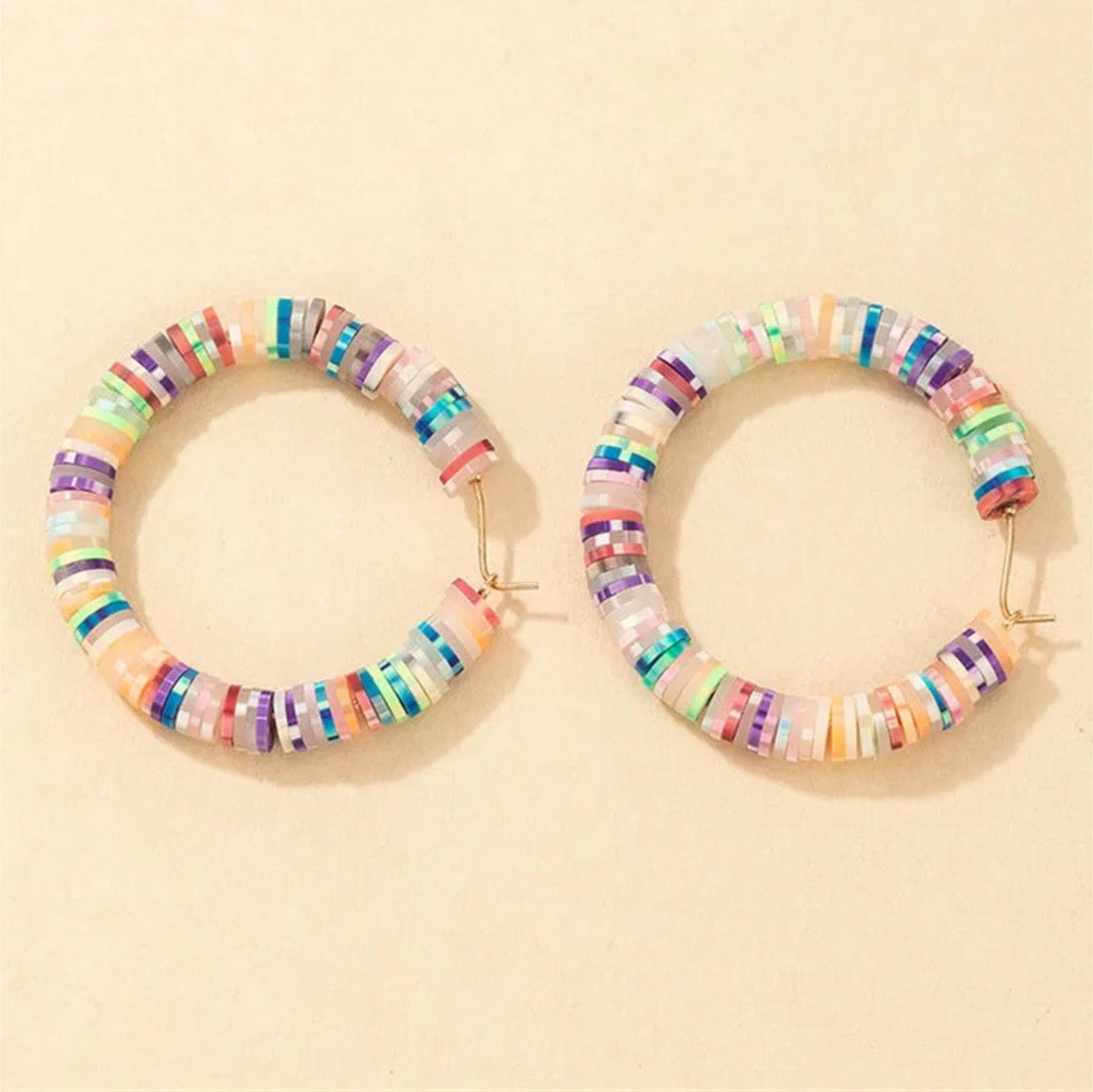 Pair of multicoloured beaded hoop earrings, front view