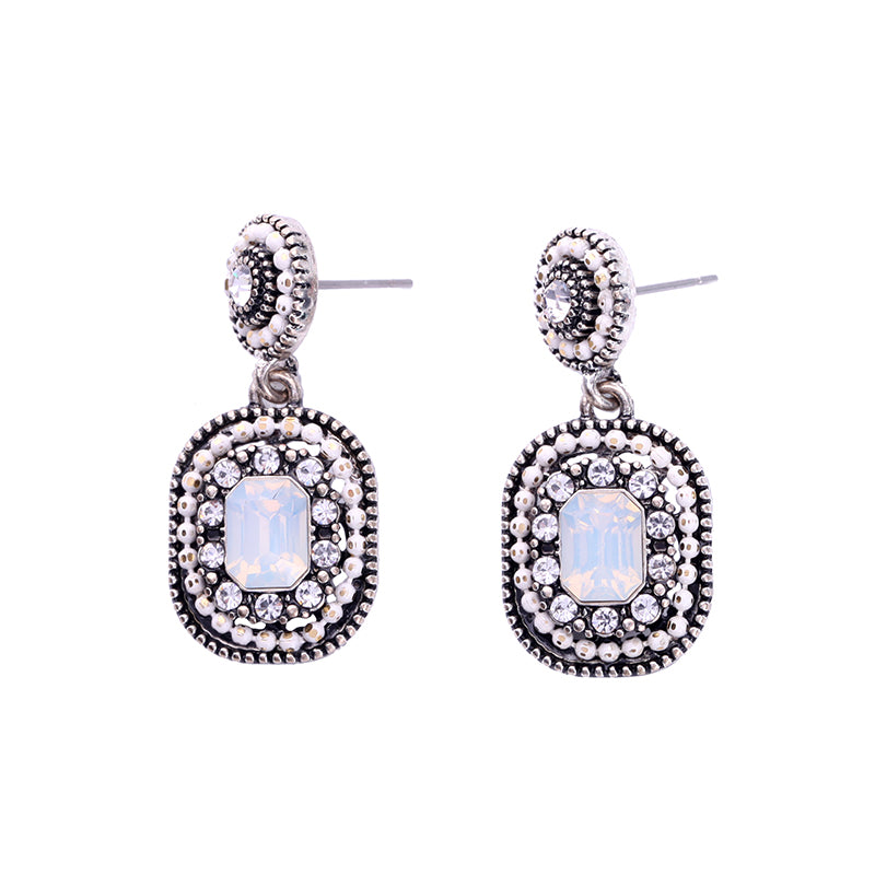 Front view of vintage-style pale opal-coloured crystal drop earrings