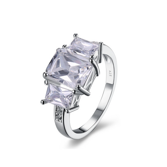 Silver ring with a large clear gemstone on a white background