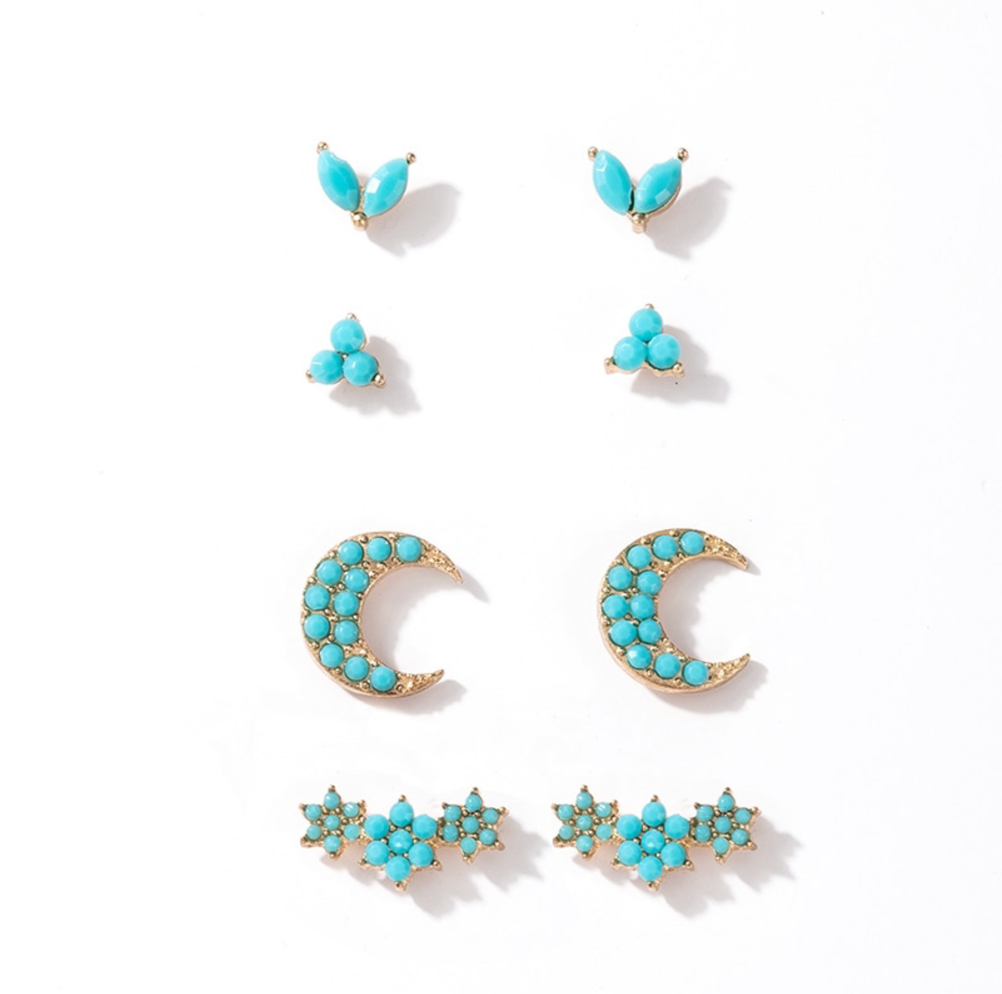 Four pairs of goldtone turquoise-colored stud earrings with crescent moon, leaf and clustered designs