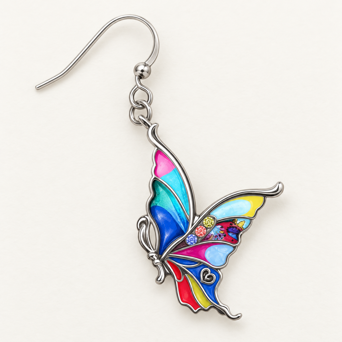 Close-up of multicolour enamel butterfly wing panels and silver-tone outlines