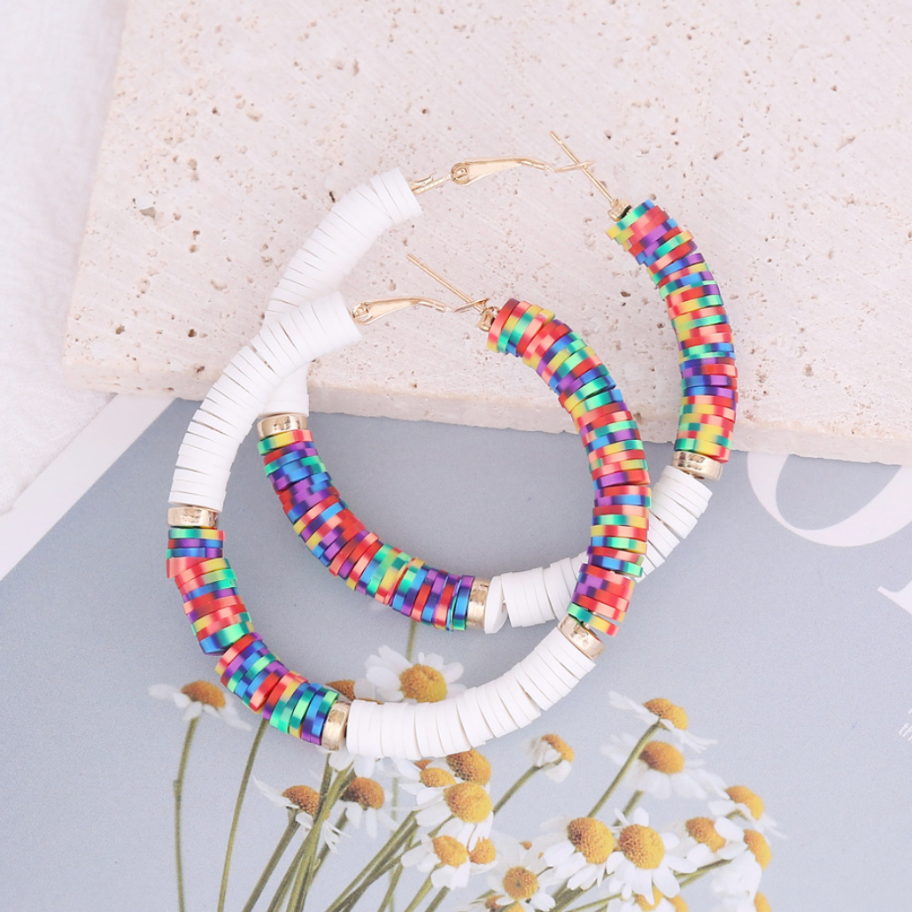 Colourful bead hoop earrings with white rectangular bead sections, styled product view