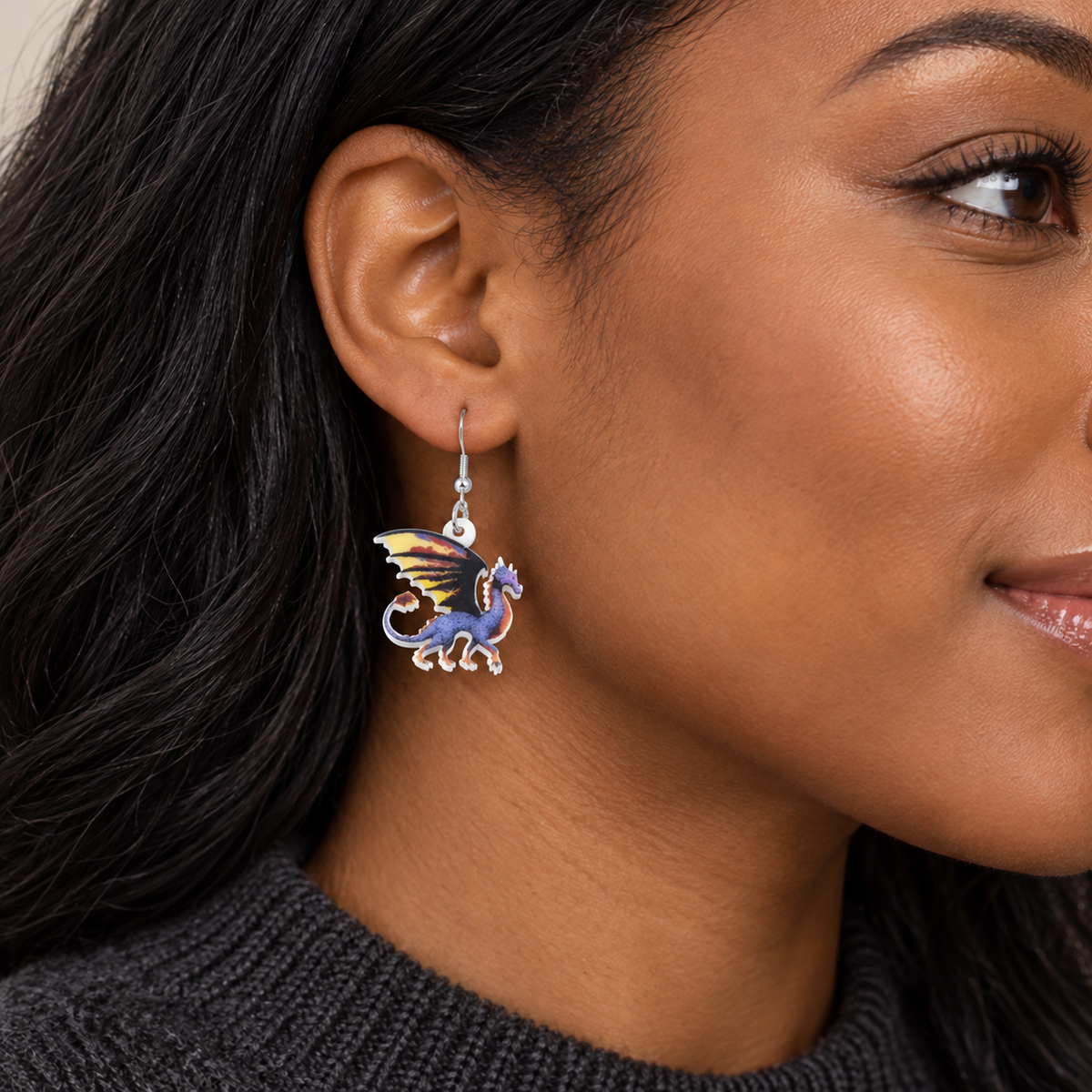 Purple dragon acrylic drop earring worn by a model with her hair behind her ear