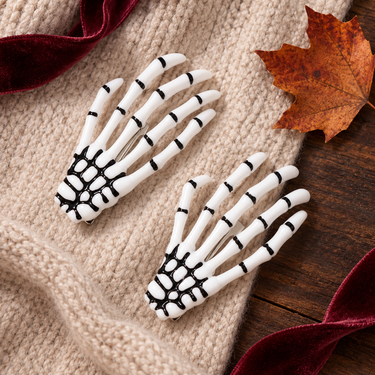 White skeleton hand Halloween barrettes on a beige knit sweater
