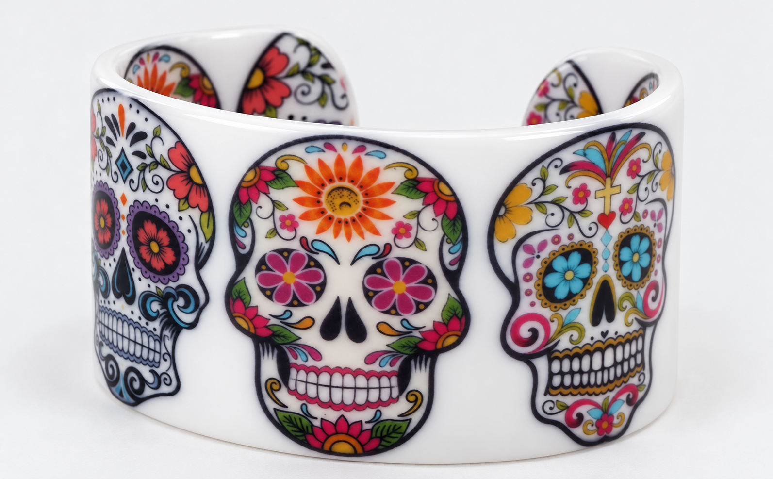 Angled view of white open cuff with floral sugar skull print