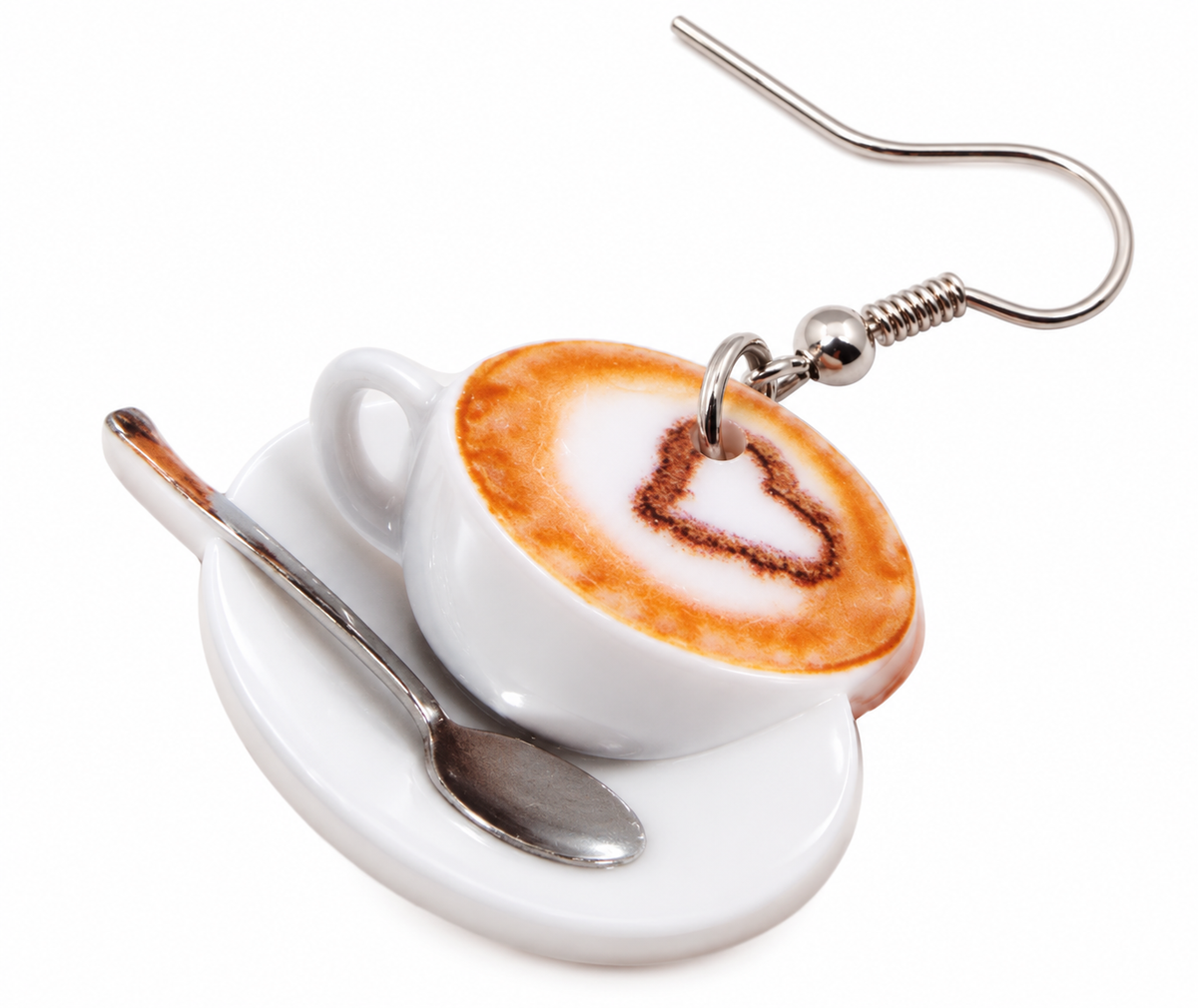 Close-up of one white coffee cup earring with brown heart latte art and spoon