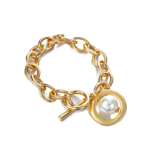 A gold-tone chain link bracelet with an imitation pearl charm attached to a circular pendant.
