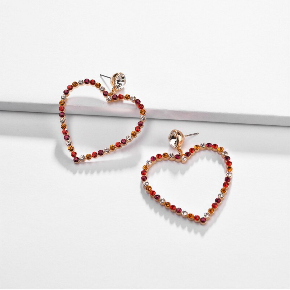 Open-heart hoop earrings edged with red crystals