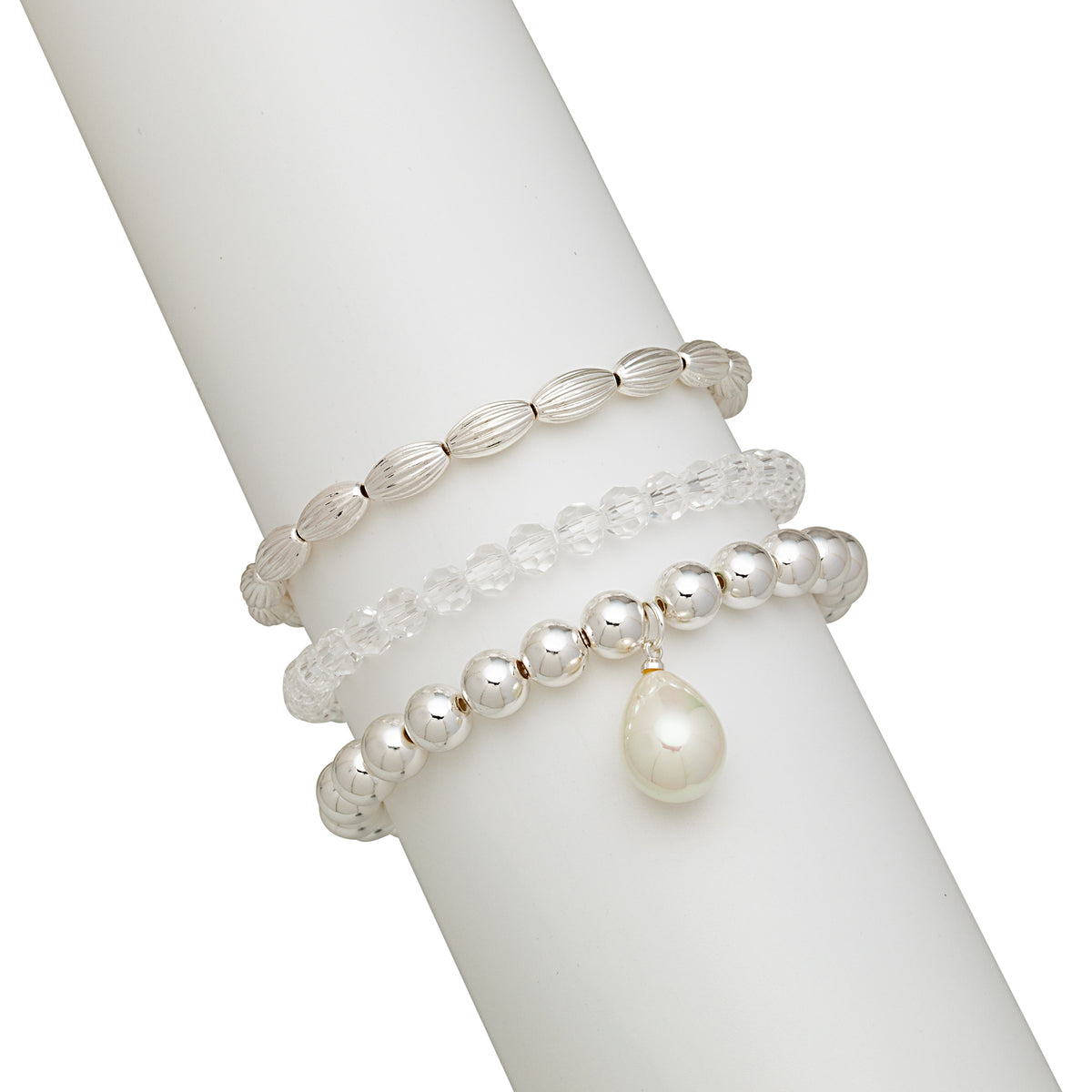 Clear beaded and faux pearl stretch bracelets displayed on a white stand