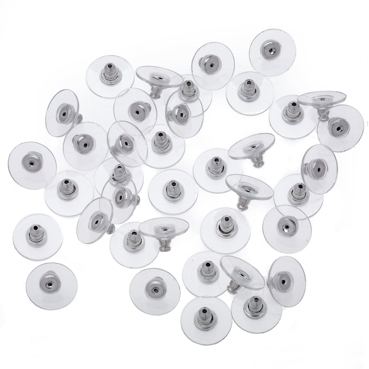 Clear circular earring backings with silver-tone centres arranged on white