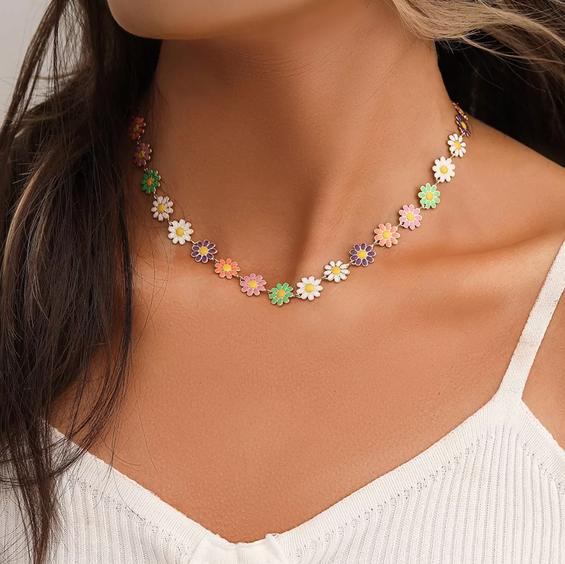 Model wearing a choker necklace of small pastel daisy flowers
