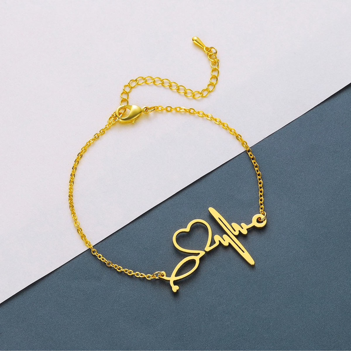 Goldtone adjustable bracelet with a heart and heartbeat charm