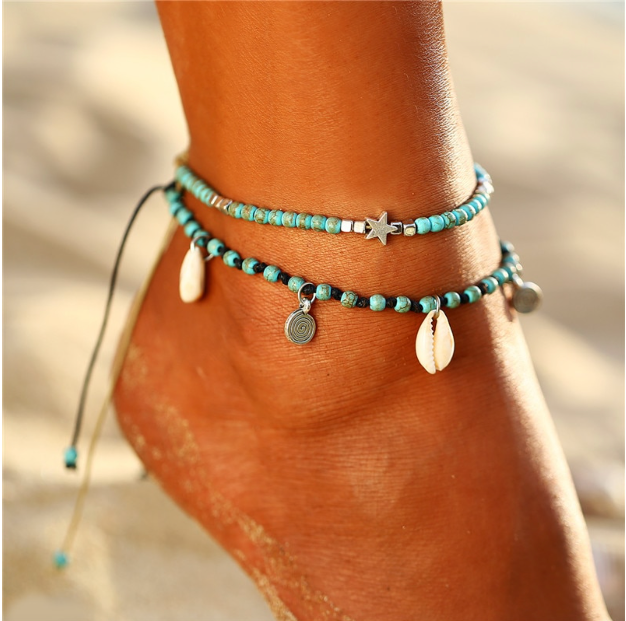 Teal beaded anklets with shell charms, worn around an ankle